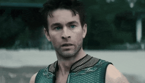 Man With Beard And Blue Eyes In Green Tank Top Looking At Camera GIF