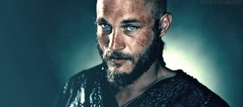 Man With Beard And Blue Eyes Next To Ponytail Man GIF