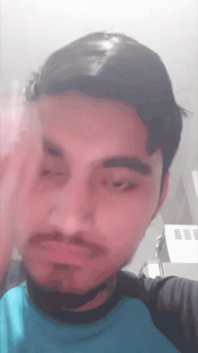 Man With Beard and Blue Shirt Making Face