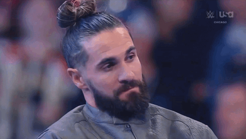 Man with Beard and Bun Sitting in Chair