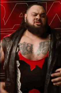 Man With Beard and Chest Tattoos Wearing Black Leather Vest