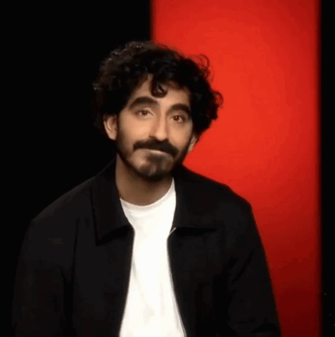 Man With Beard And Curly Hair In Black Jacket And White Shirt GIF