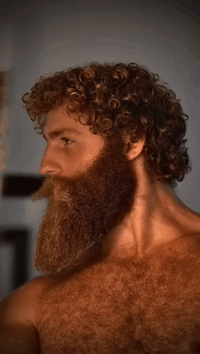 Man With Beard And Curly Hair Looking Sideways GIF