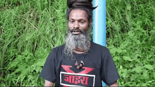 Man With Beard And Dreadlocks In Black T-Shirt And Blue Pole GIF