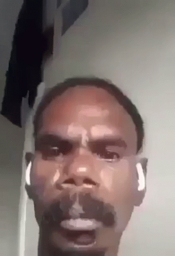 Man with Beard and Earbuds Making Funny Face