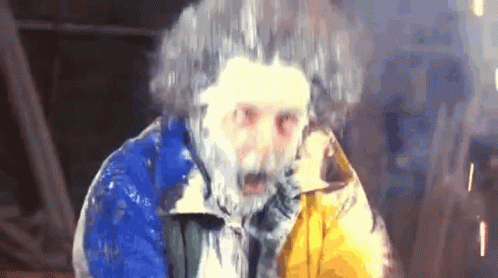 Man With Beard And Frozen Hair In Blue And Yellow Jacket GIF