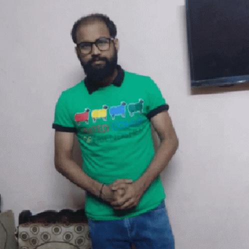 Man With Beard and Glasses in Green Shirt Saying United Colors of Benetton