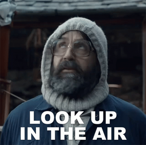 Man With Beard and Glasses in Hoodie Saying Look Up in the Air
