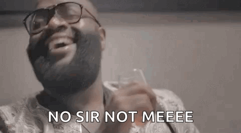 Man with Beard and Glasses Laughing Holding Water