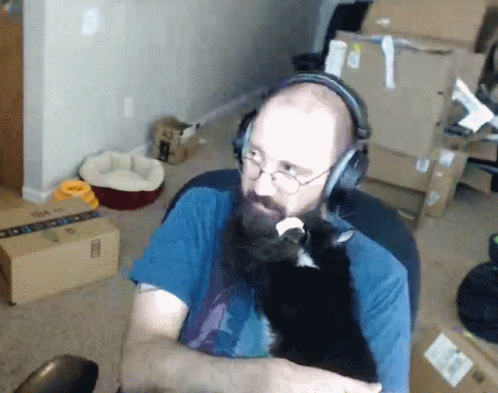 Man with Beard and Glasses Touching Chin