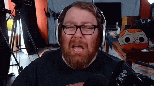 Man with Beard and Glasses Wearing Headphones