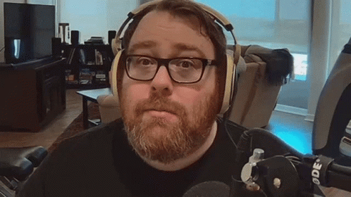 Man with Beard and Glasses Wearing Headphones