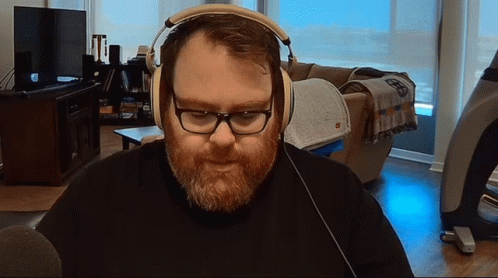 Man with Beard and Glasses Wearing Headphones