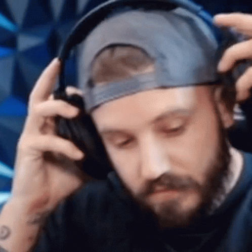 Man with Beard and Hat Wearing Headphones