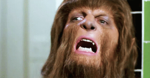 Man With Beard and Long Hair Making Funny Face