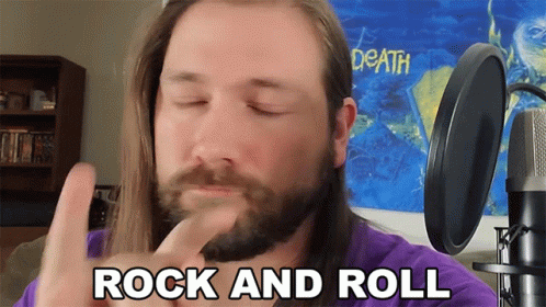 Man With Beard and Long Hair Says Rock and Roll