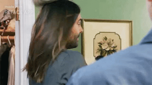 Man With Beard And Long Hair Standing Next To Woman With Long Hair GIF