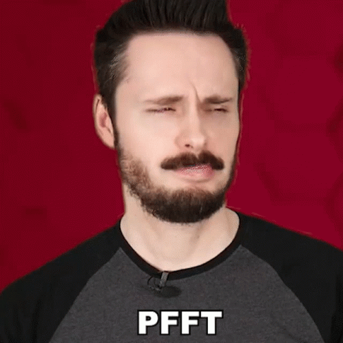 Man With Beard and Mustache in Gray Shirt Saying Pfft