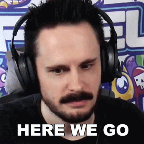 Man With Beard and Mustache Wearing Headphones Saying Here We Go