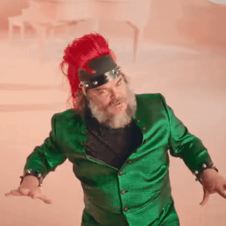 Man With Beard and Red Hair in Green Jacket and Red Hat