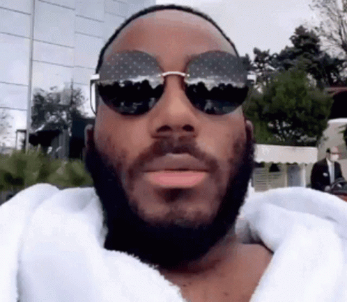 Man With Beard And Sunglasses In White Robe GIF