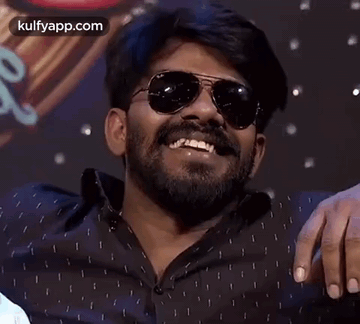 Man with Beard and Sunglasses Laughing