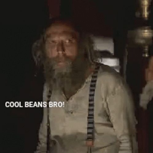 Man with Beard and Suspenders Giving Thumbs Up
