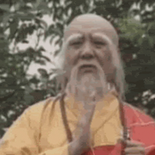 Man with Beard and Yellow Robe Holding Sword
