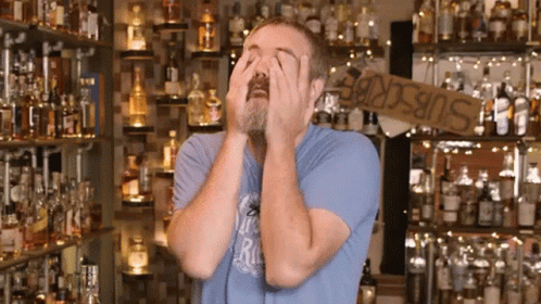 Man With Beard Covering Eyes In Front Of Subscribe Sign GIF