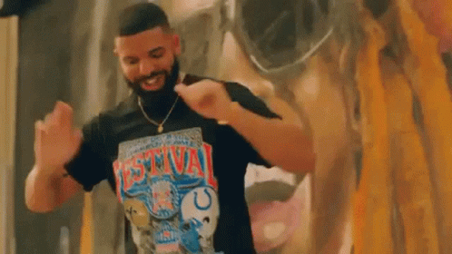 Man with Beard Dancing in Front of Mural