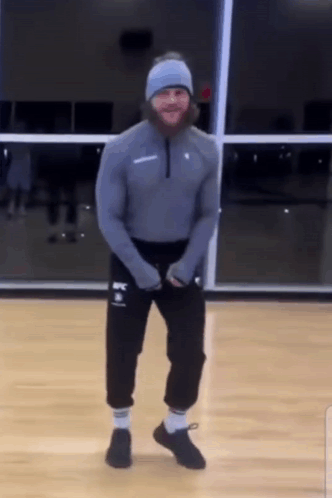 Man With Beard Dancing in Gym Wearing UFC Sweatshirt