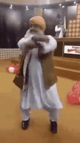 Man With Beard Dancing In Room With Balloons GIF
