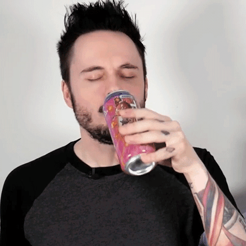 Man With Beard Drinking From Pink Can