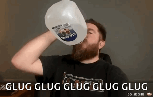 Man With Beard Drinking Gallon of Water