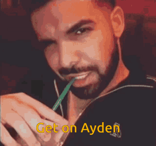 Man with Beard Drinking Through Green Straw