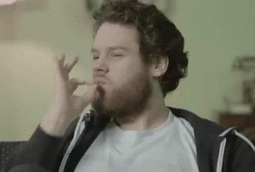 Man With Beard Eating Food on Couch