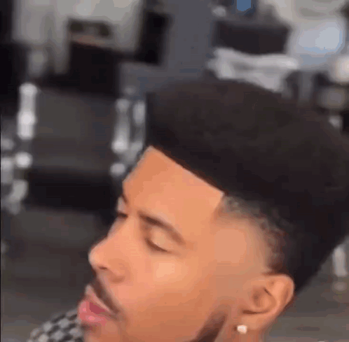 Man With Beard Getting Haircut by Barber