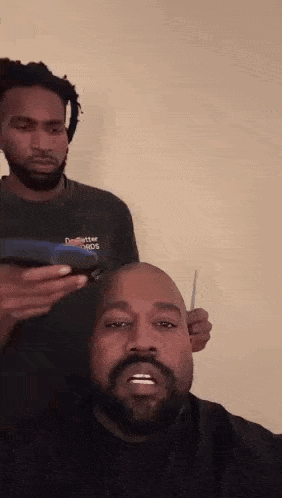 Man with Beard Getting Head Shaved by Dreadlocked Barber