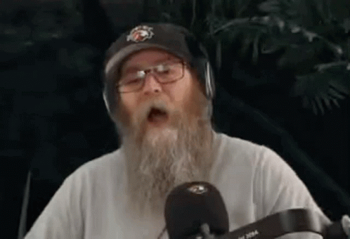 Man With Beard Glasses Headphones Singing Into Mic