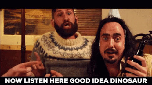 Man With Beard Holding Beer Next to Another Man With Beard