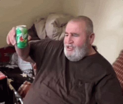 Man with Beard Holding Can of 7 Up