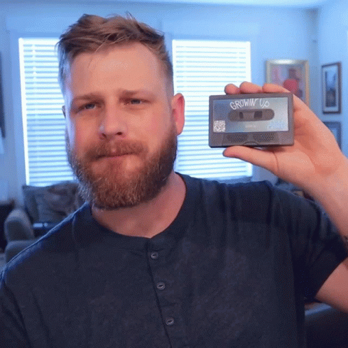 Man With Beard Holding Cassette Tape Saying Growin' Up