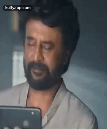 Man With Beard Holding Cell Phone