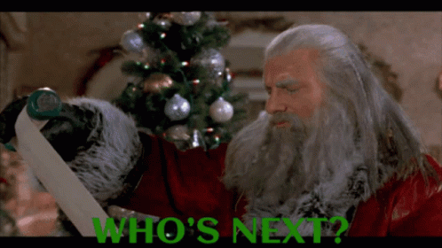 Man With Beard Holding Green Paper Saying Who's Next GIF