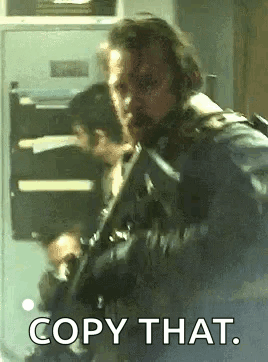 Man With Beard Holding Gun Saying Copy That