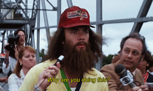 Man with Beard Holding Microphone Asking Why