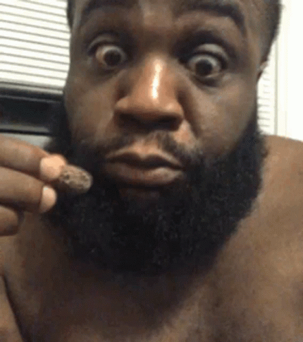 Man with Beard Holding Something