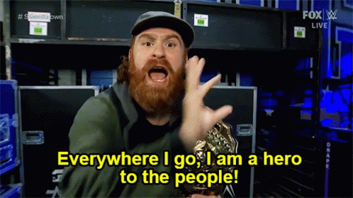 Man with Beard Holding Trophy Everywhere I Go I Am a Hero to the People