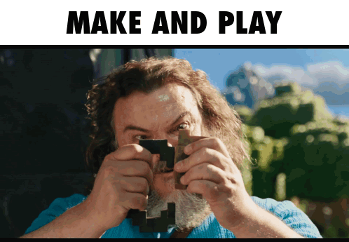 Man With Beard Holding Wood in Front of Make and Play Sign