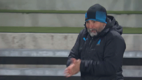 Man with Beard in Black Jacket and Blue Hat